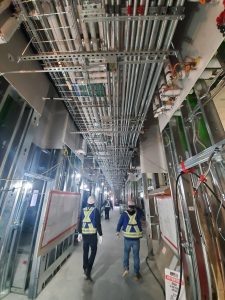 Two Modern Niagara employees walk down hallway in project site