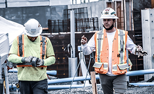 Two Modern Niagara employees with safety equipment working on a project site